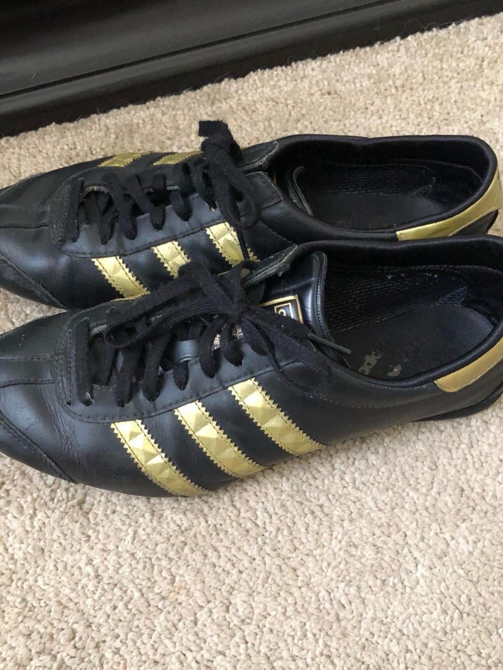 adidas Women’s Black Sneakers with Gold Stripes